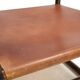 Fauteuil Manou en rotin et assise en cuir, 1960