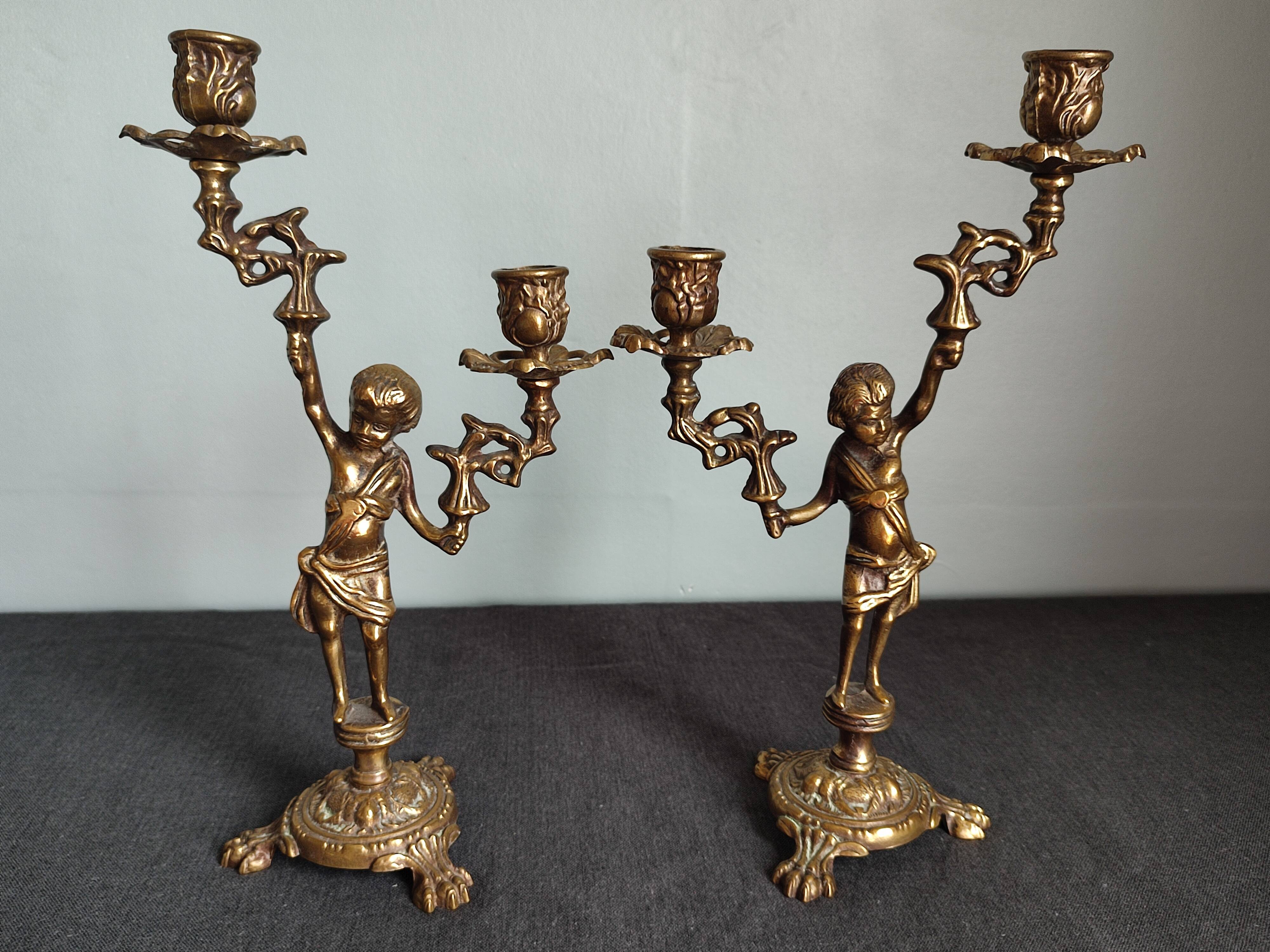 Pair of antique candlesticks in cherub bronze