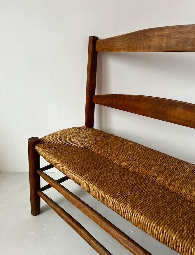 Old wooden and straw bench