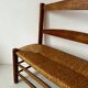 Old wooden and straw bench