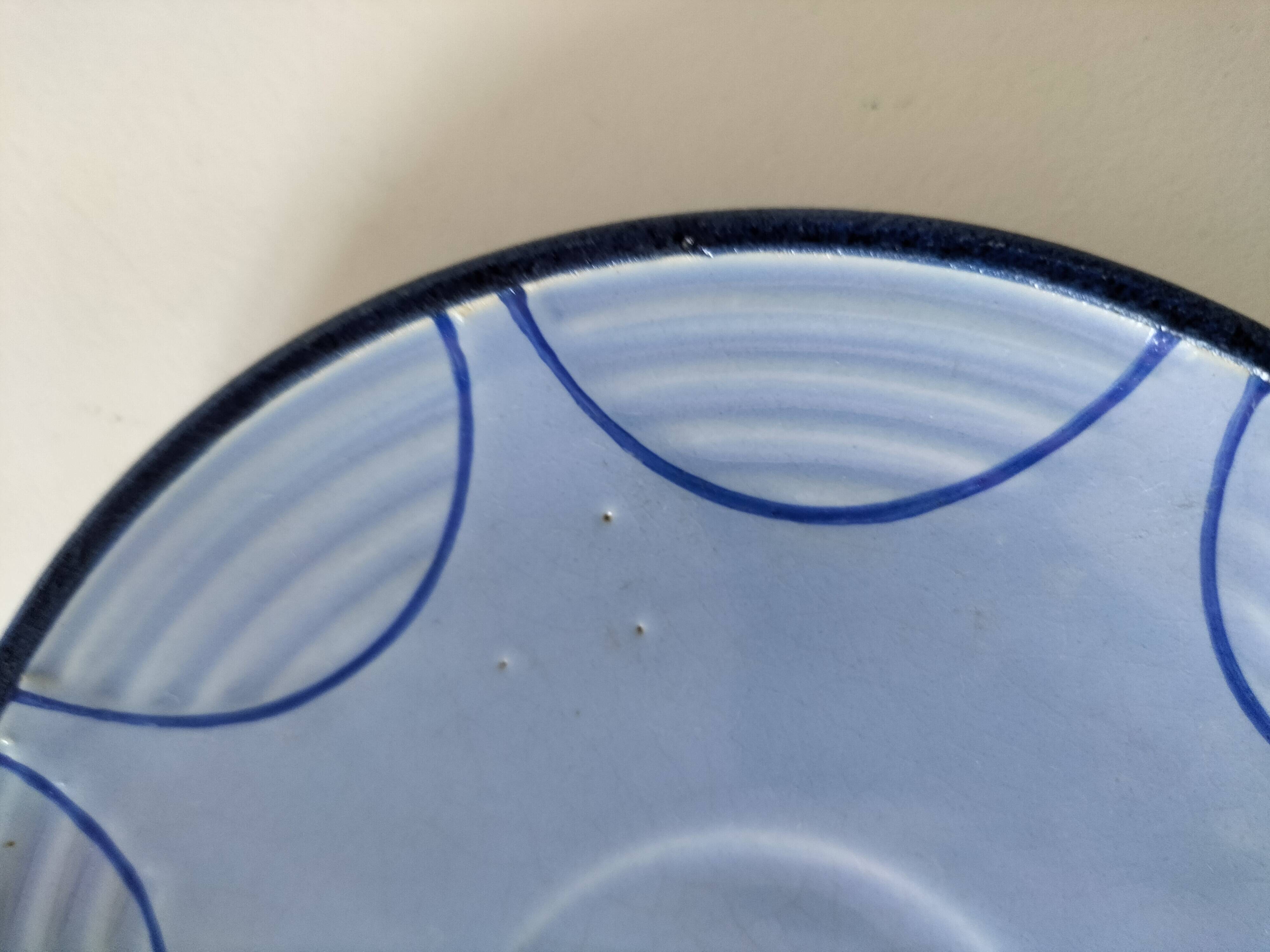 A pair of glazed ceramic cups and saucers from the 60s-70s.