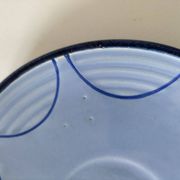 A pair of glazed ceramic cups and saucers from the 60s-70s.