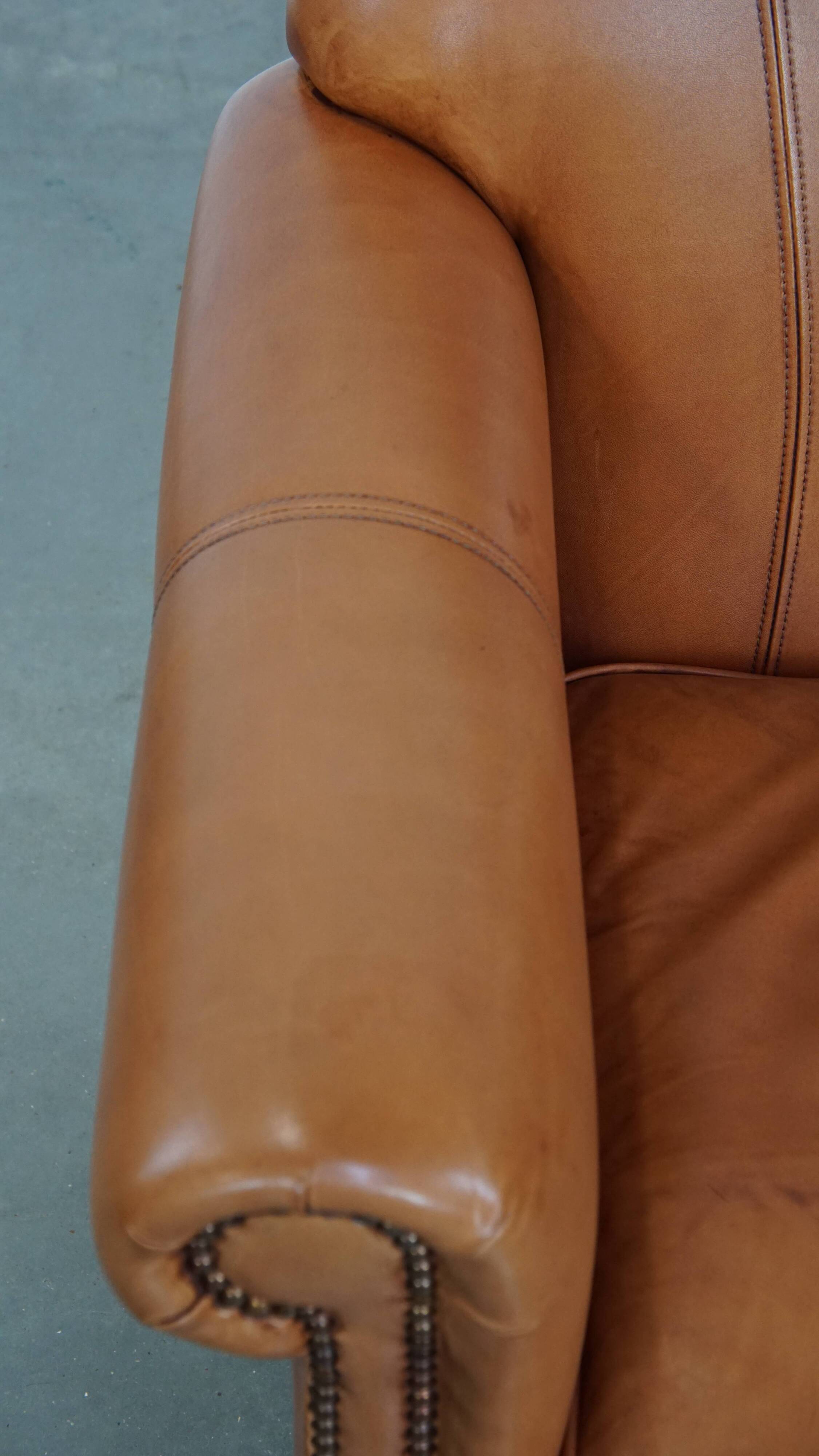 Cognac-colored cowhide leather armchair