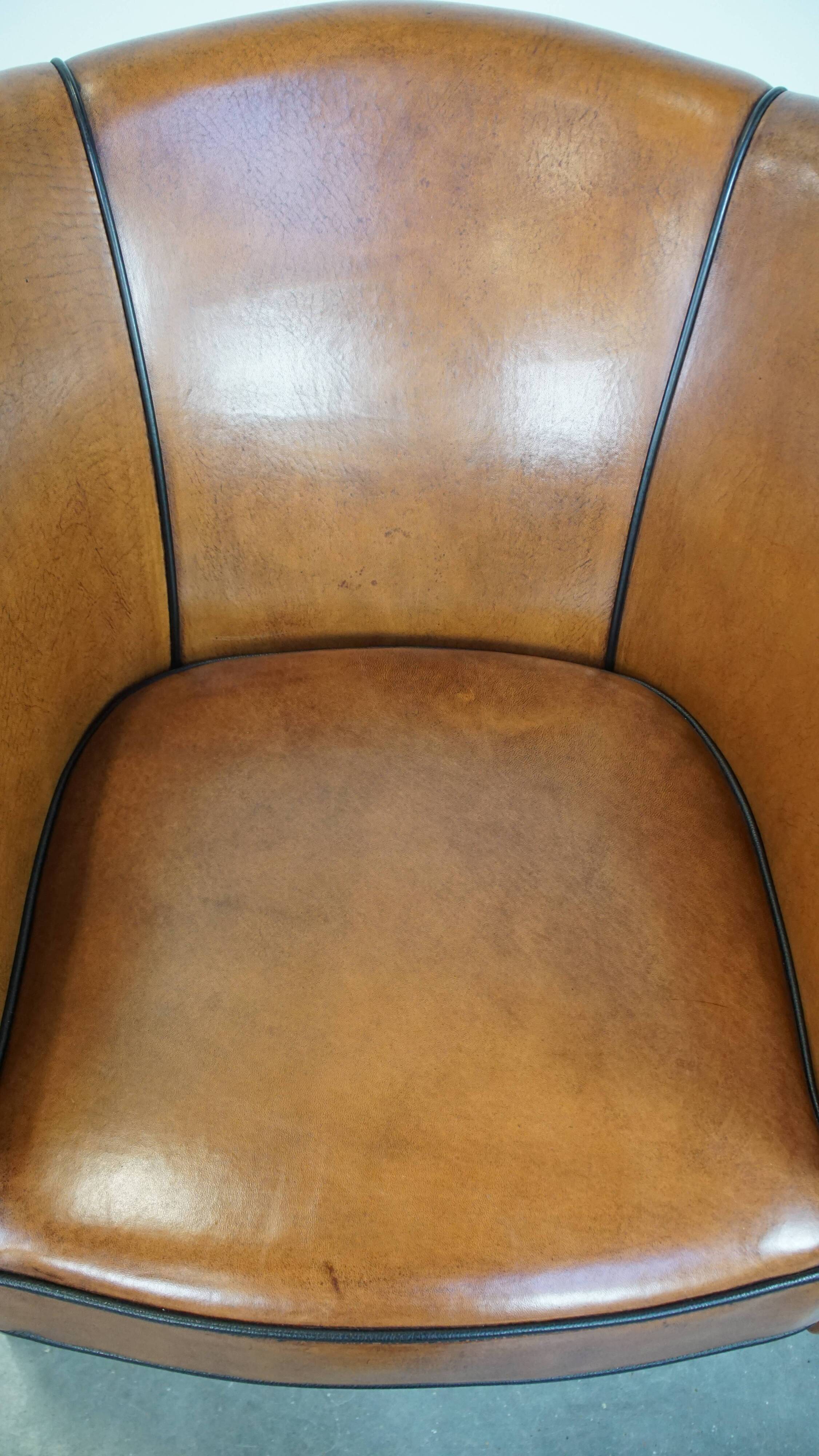 Sheep leather club chair finished with black piping
