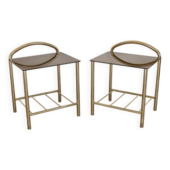 Pair of bedside tables with gold metal and mirrored glass top.