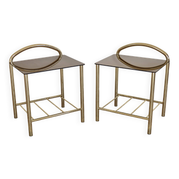 Pair of bedside tables with gold metal and mirrored glass top.