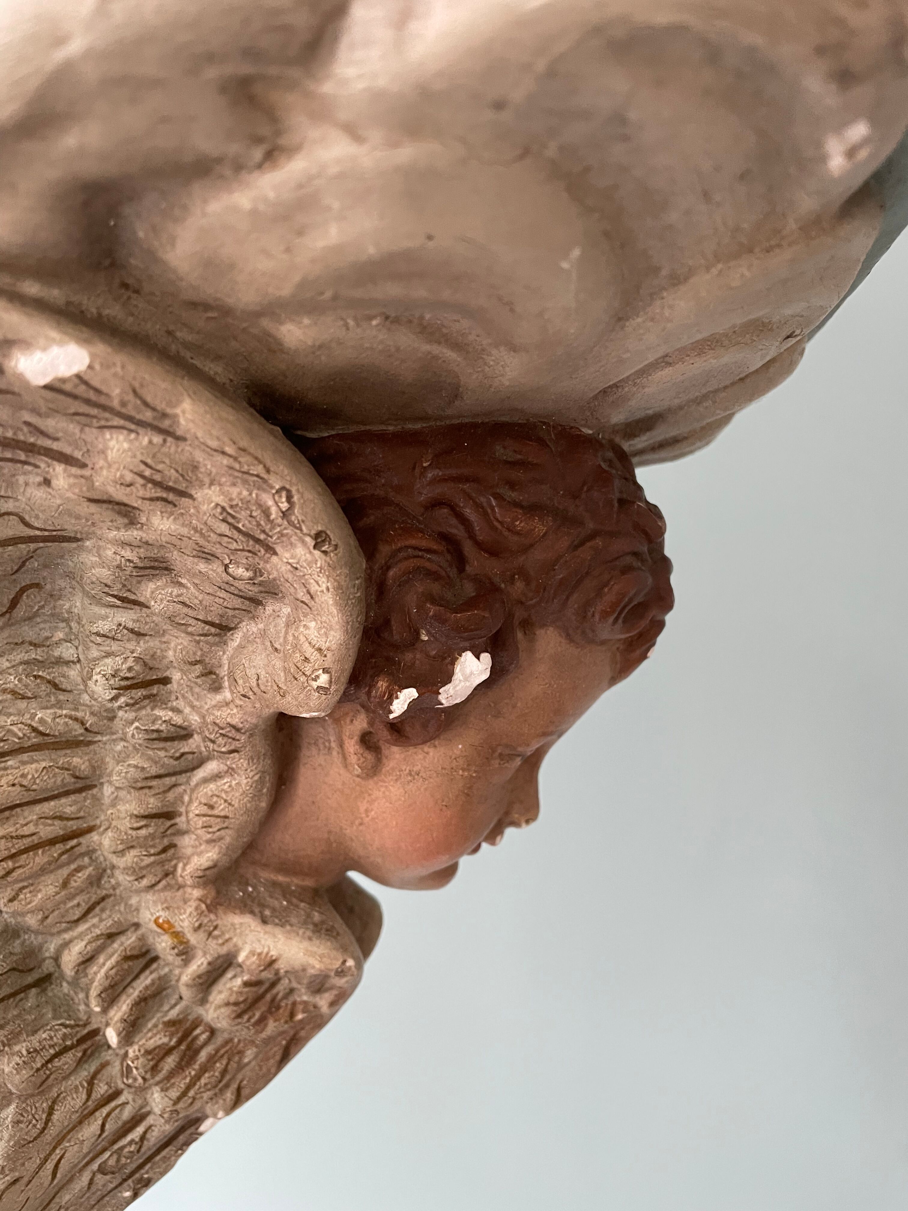 Nineteenth century plaster wall console, cherub decoration