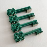 4 green ceramic knife rests in vintage key shape
