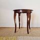 Vintage solid wood side table with curved legs.