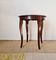 Vintage solid wood side table with curved legs.