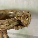 Alabaster bowl decorated with vine leaves on a base of three dolphins, circa 1880.