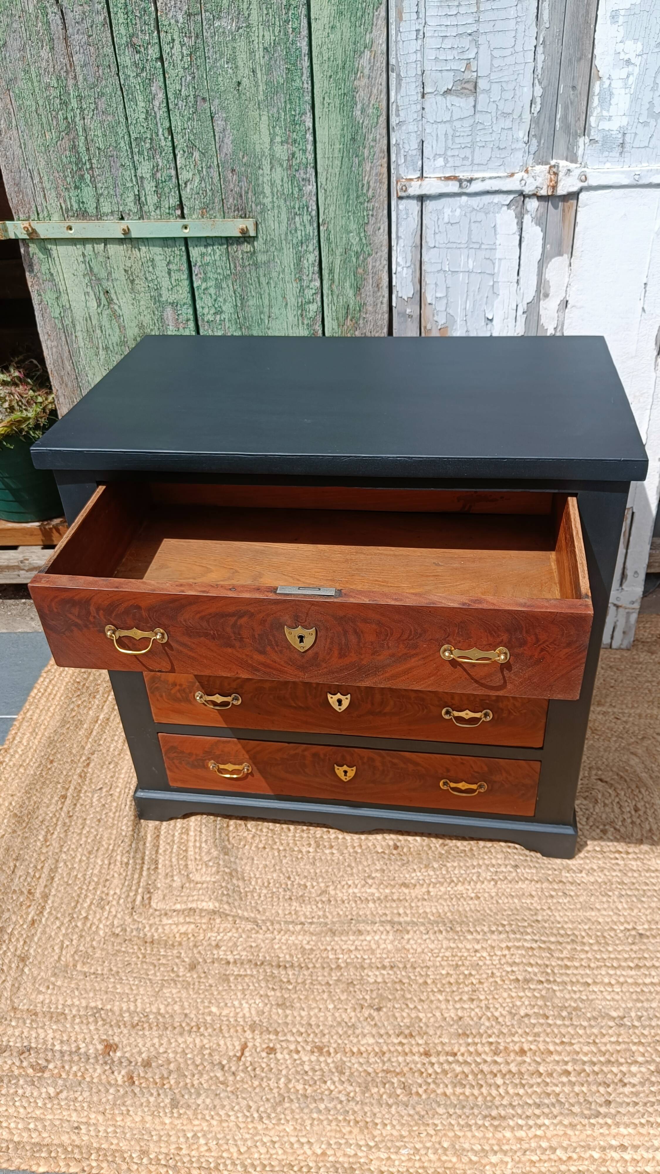 Vintage commode revamped in matte black & wood with warm tones.