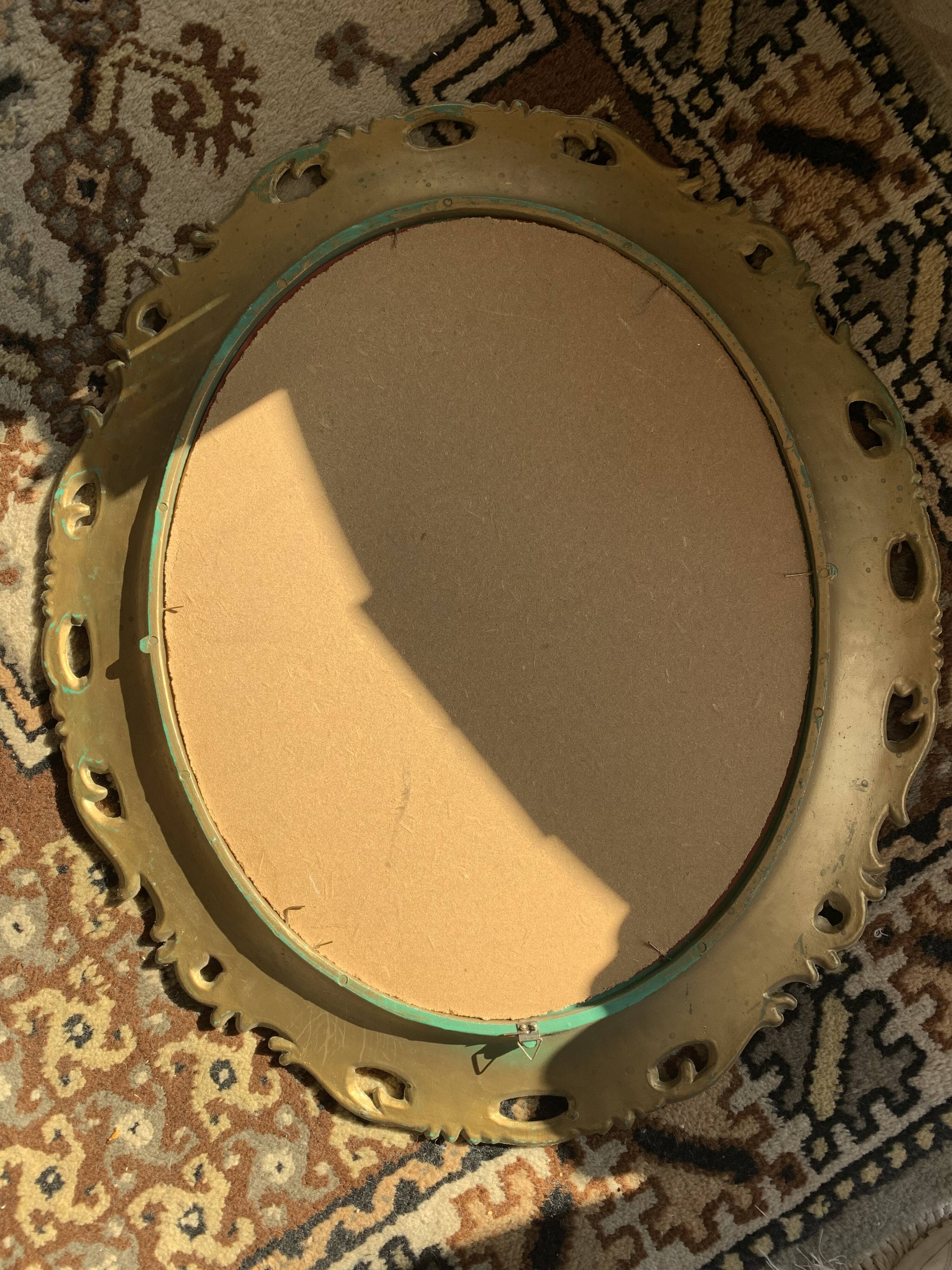 Miroir ovale doré années 70