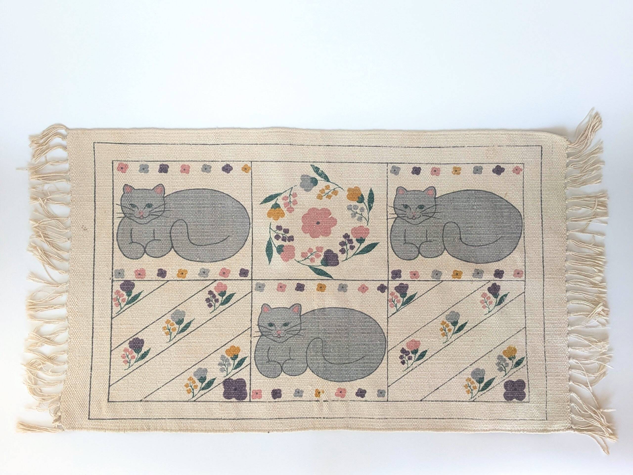 1980s handwoven cotton rug with a cat and flower pattern