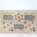 1980s handwoven cotton rug with a cat and flower pattern