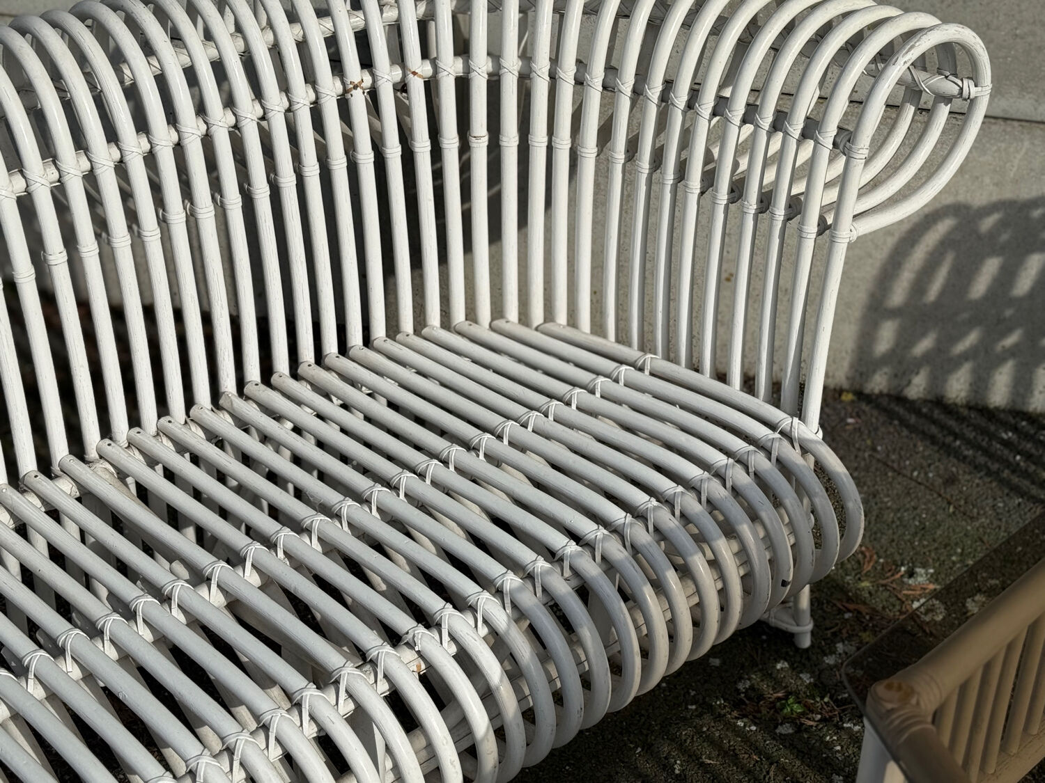 Rattan lounge with two two-seater sofas and a white coffee table.