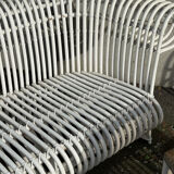 Rattan lounge with two two-seater sofas and a white coffee table.