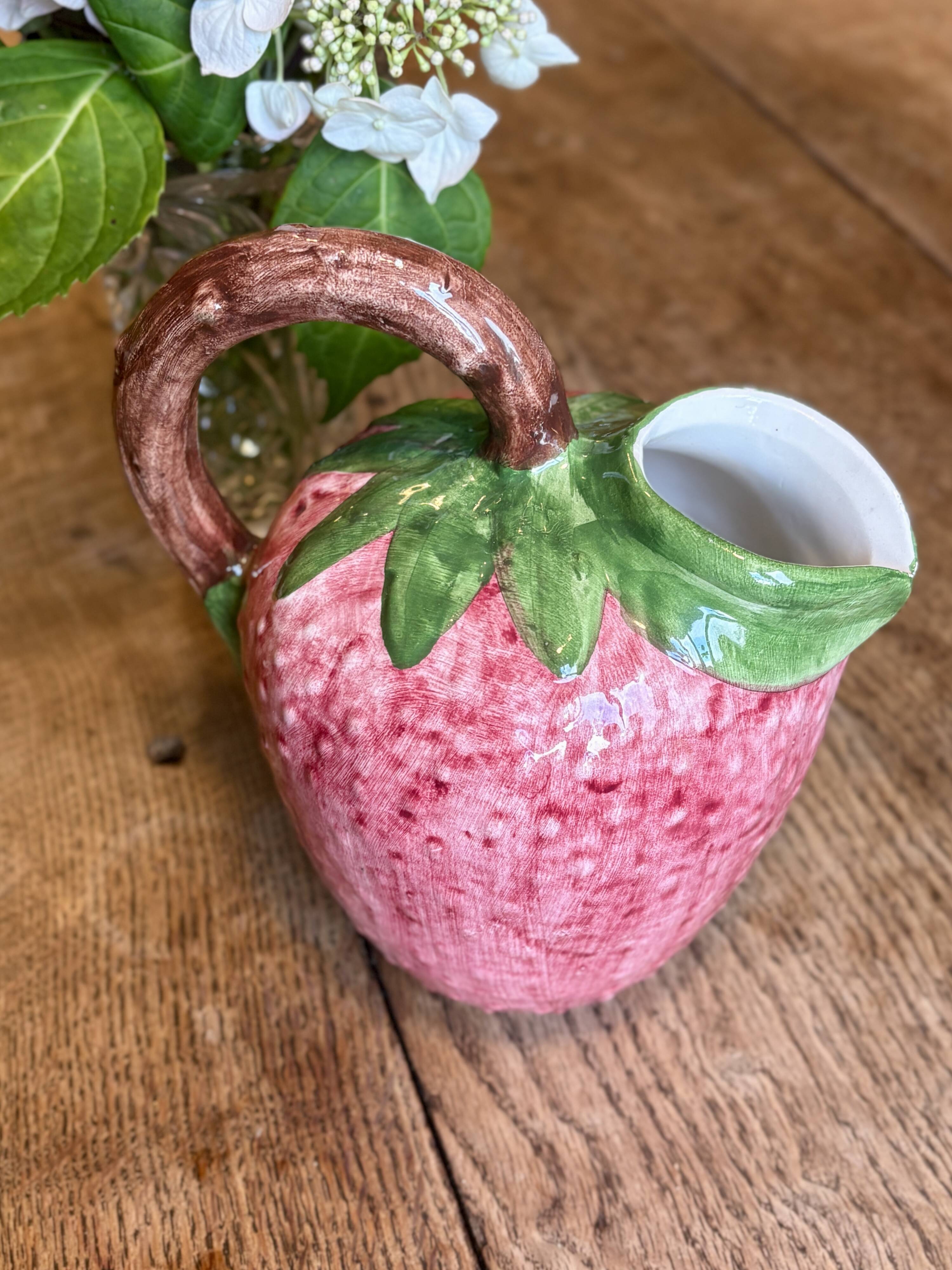 Ceramic jug in the shape of a strawberry.