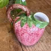Ceramic jug in the shape of a strawberry.