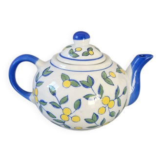 Blue teapot and yellow fruits