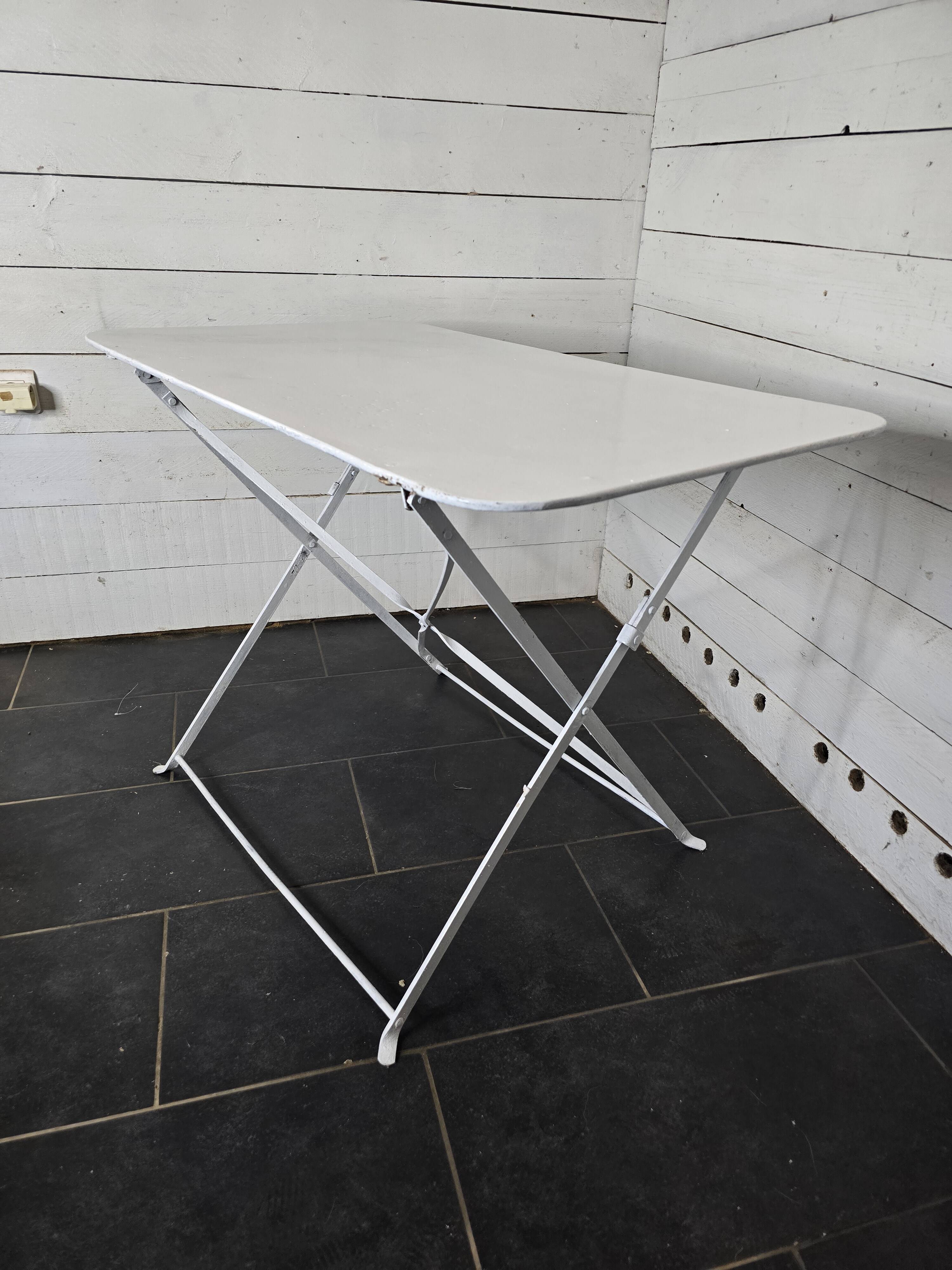 Old folding wrought iron garden table