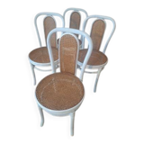 4 white rattan and cane chairs