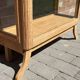 Restored antique oak display cabinet, black background, glass shelves.