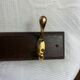 Wooden coat rack with double brass hooks