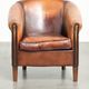 Vintage sheepskin club armchair finished with black piping