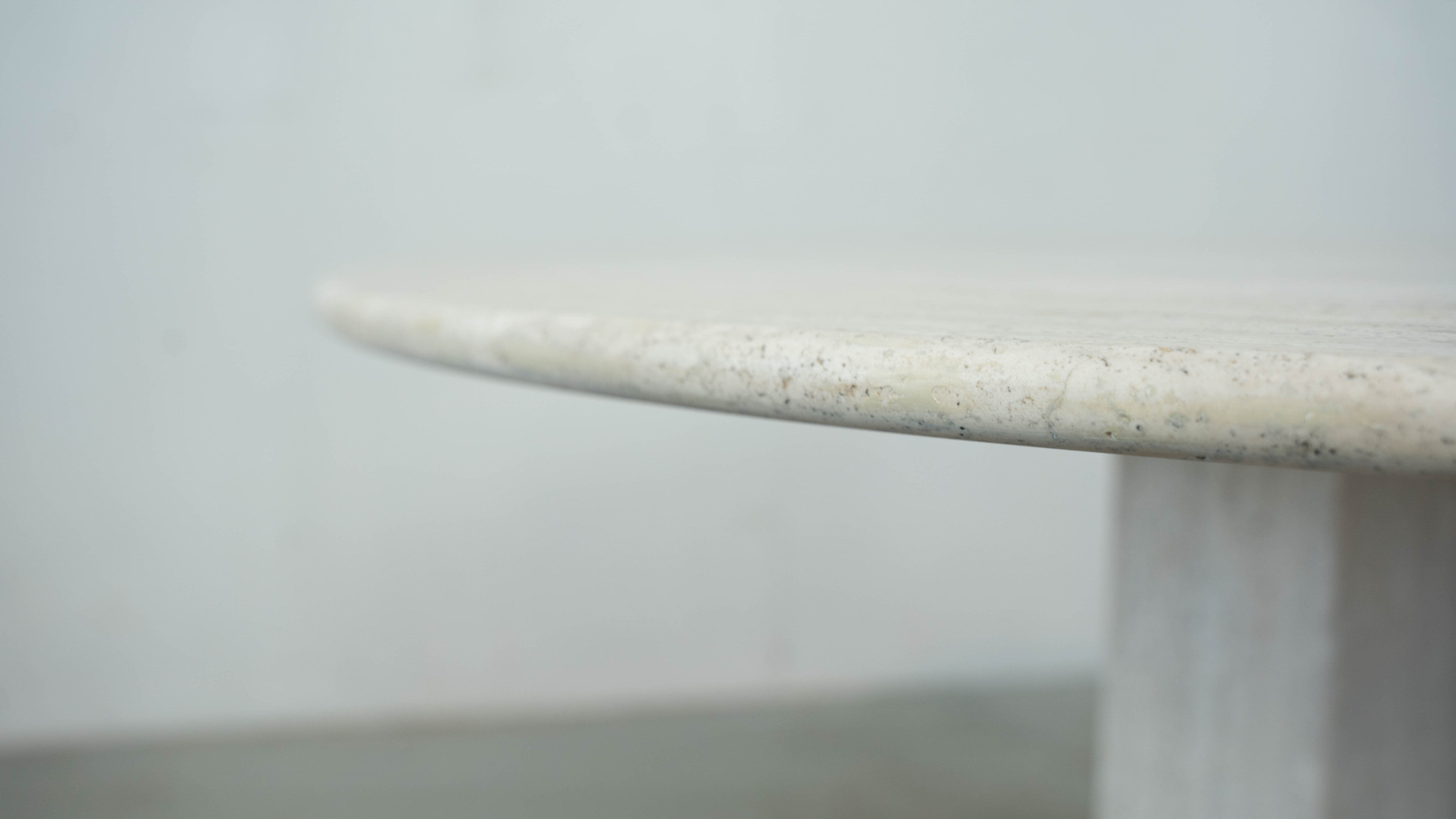 Round Belgian travertine dining table