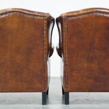 Set of 2 sheep leather wingback chairs with red corduroy seat cushions