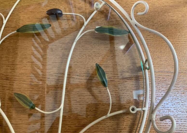 Round wrought iron and glass tray decorated with olives and foliage