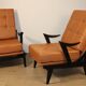 Paire de fauteuils vintage années 50 en bois noir et cuir caramel