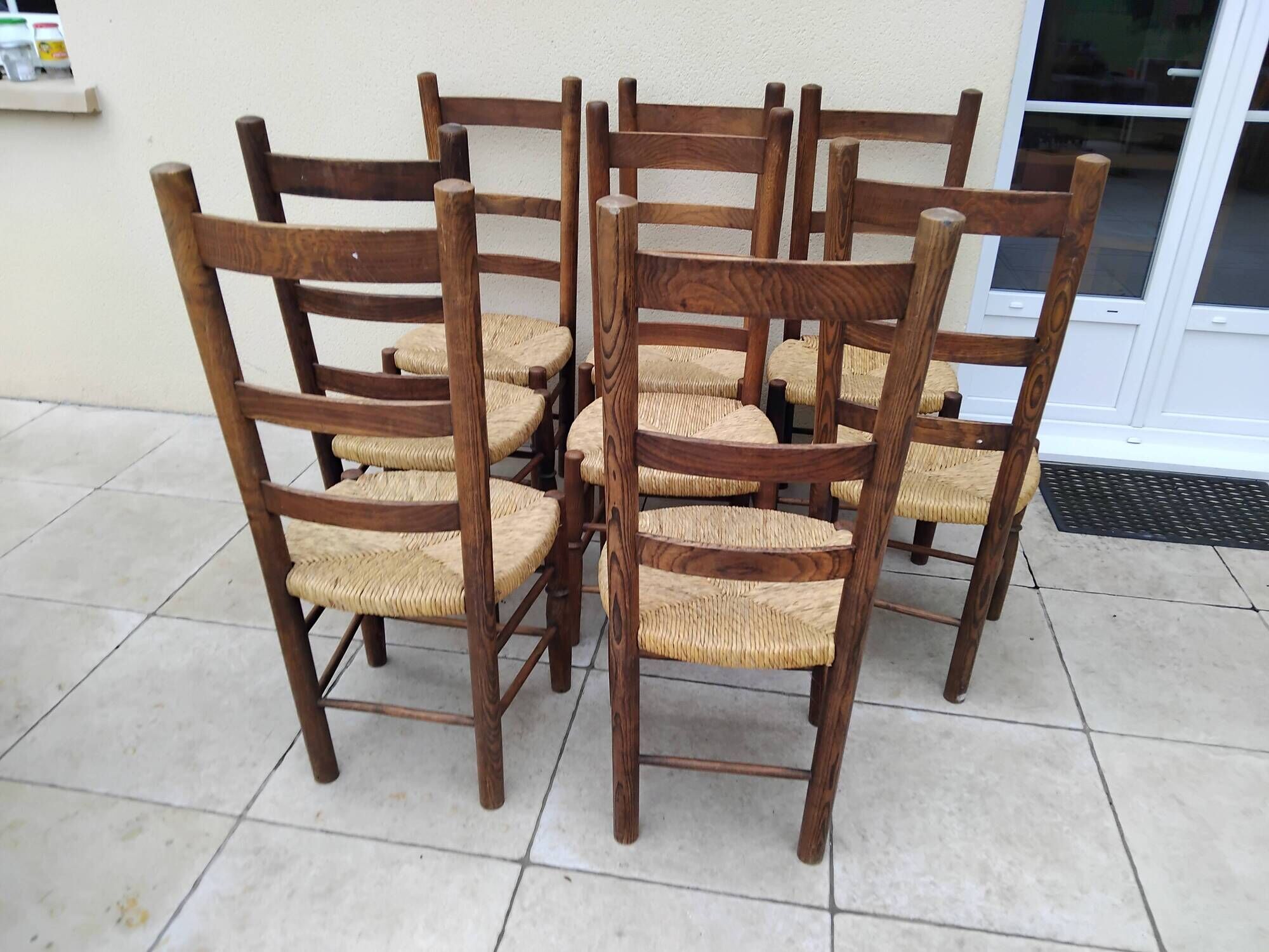 8 vintage straw chairs in the style of Charlotte Perriand.