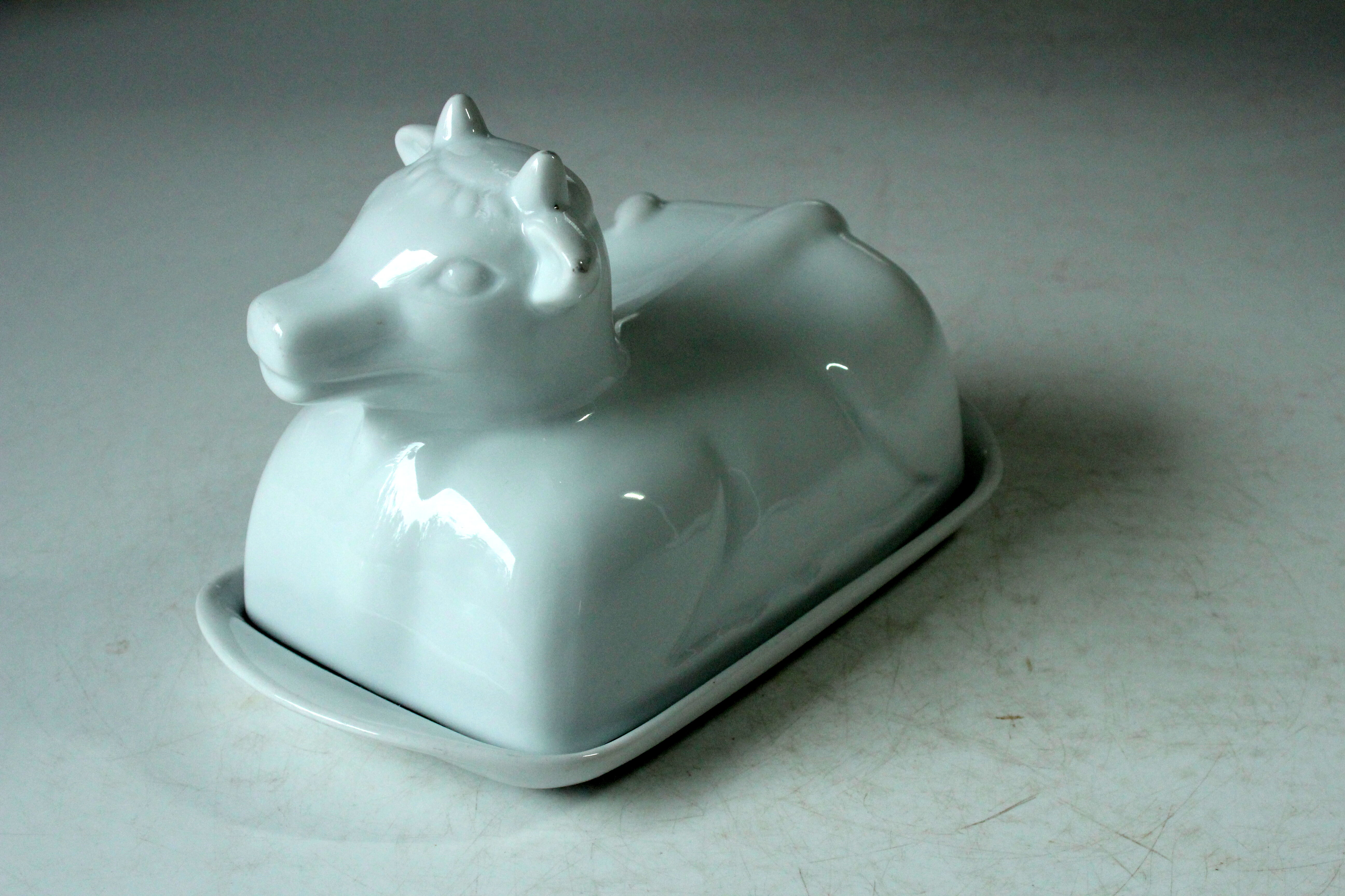 White ceramic butter dish in the shape of a cow, vintage