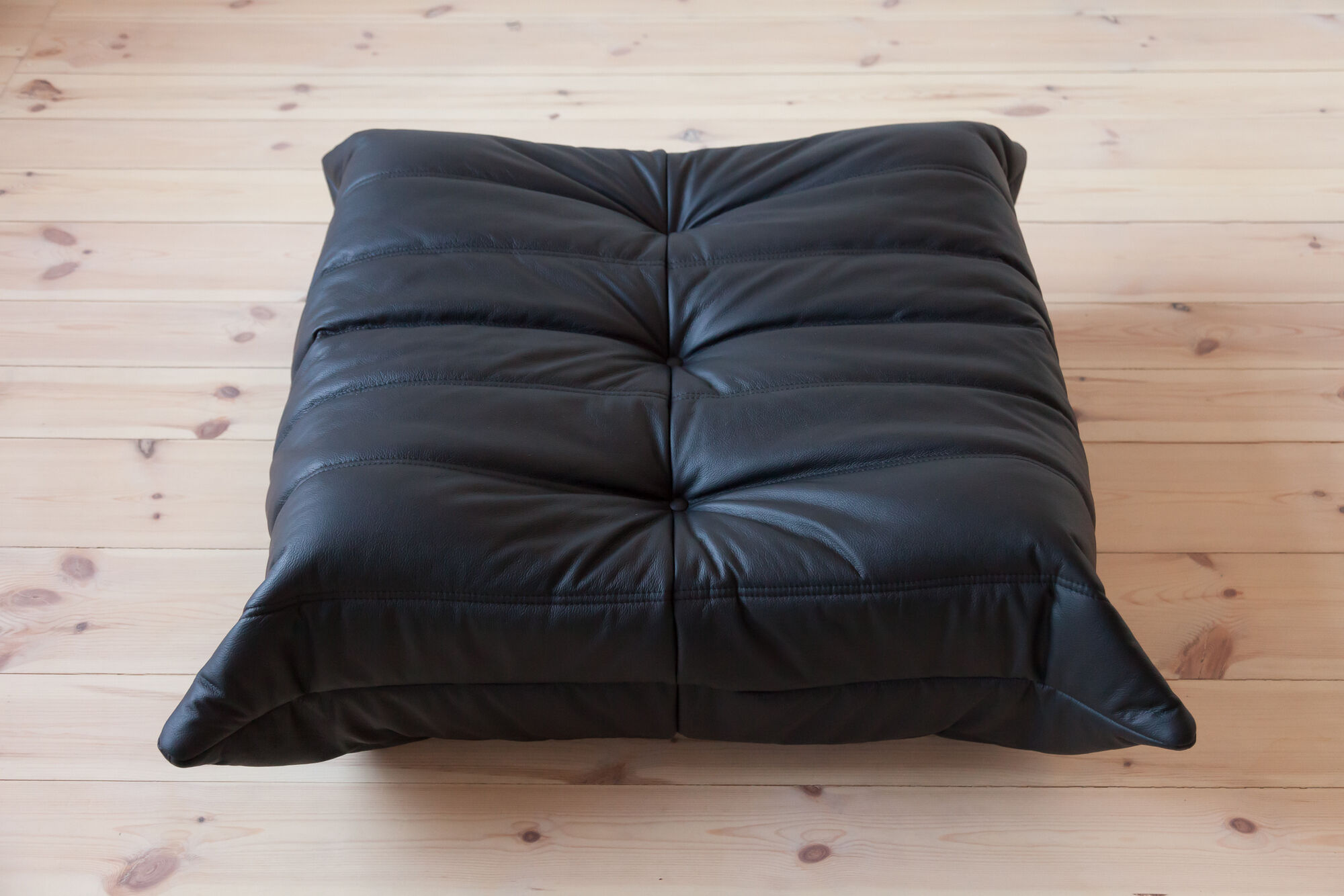Armchair and ottoman in black leather model designed by Michel Ducaroy 1973