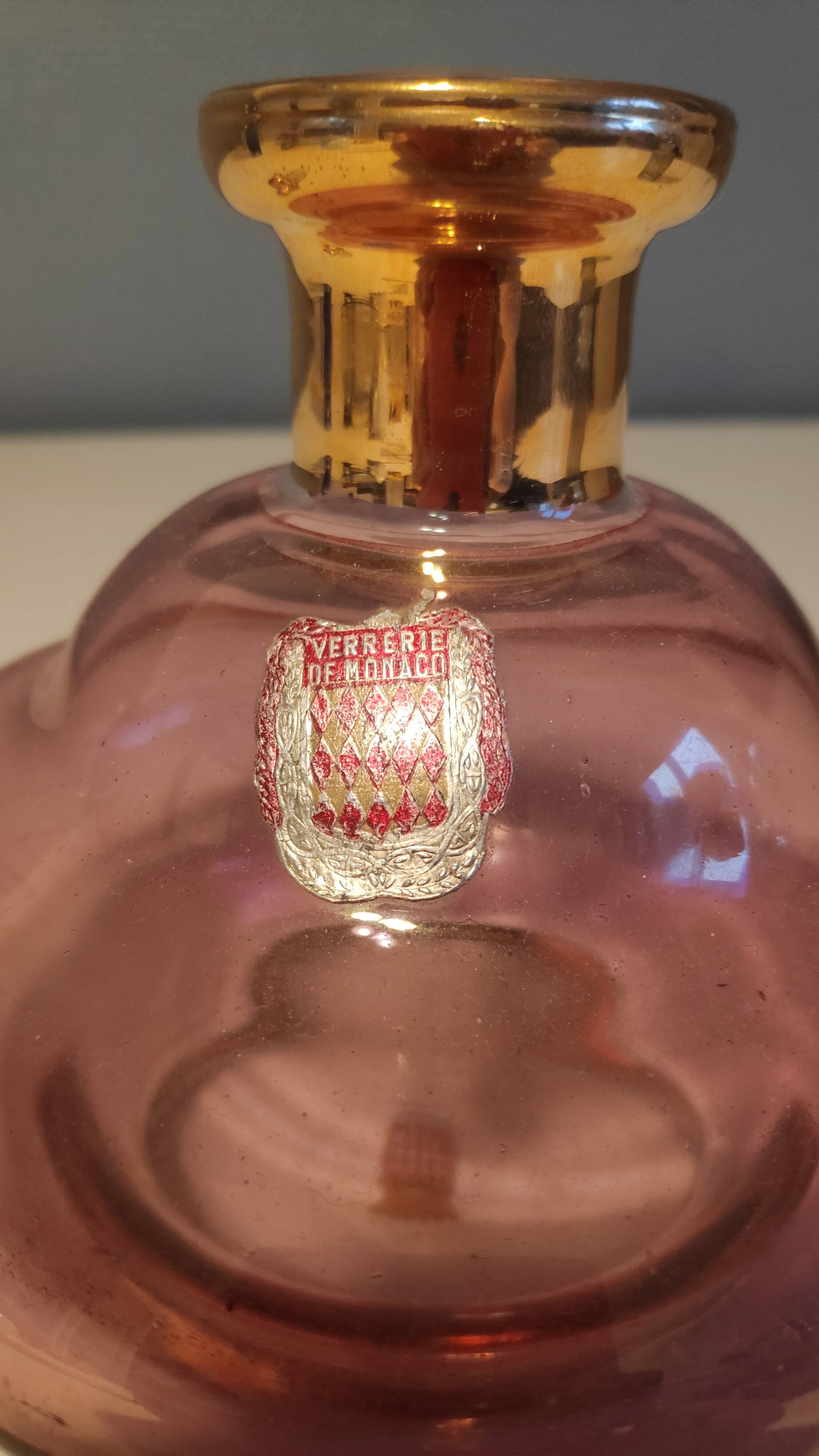 Pink and gold glass carafe stamped "Monaco glassware"