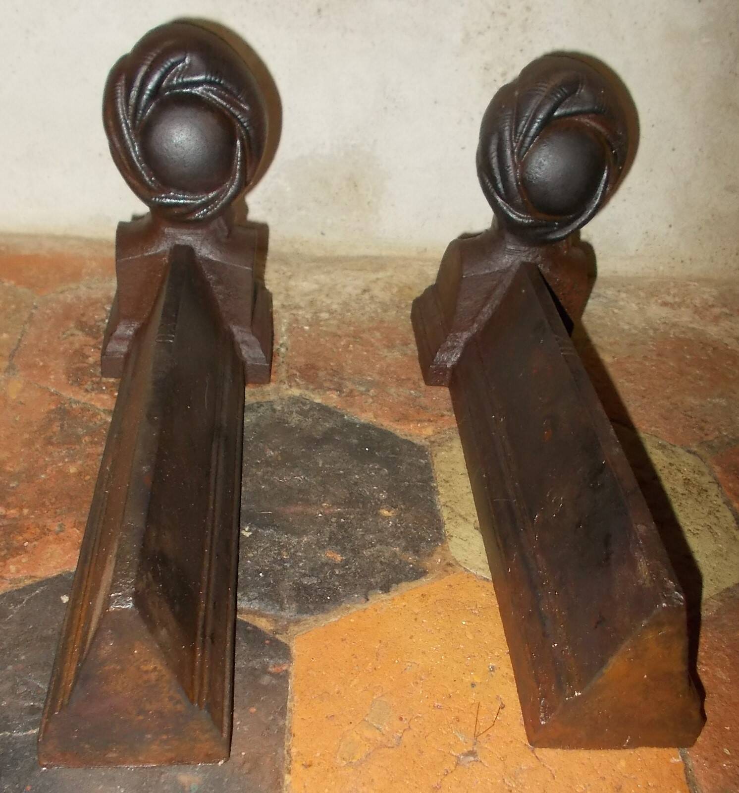Old cast iron andirons with oriental decor