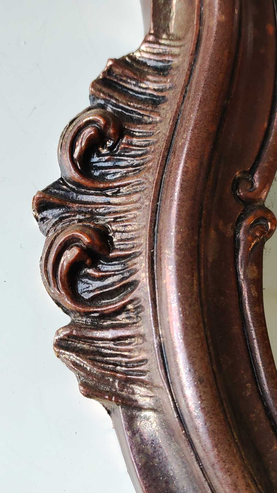 Pretty Baroque style mirror / Louis XV patinated with pink / golden copper reflections. Volutes, leafy shells