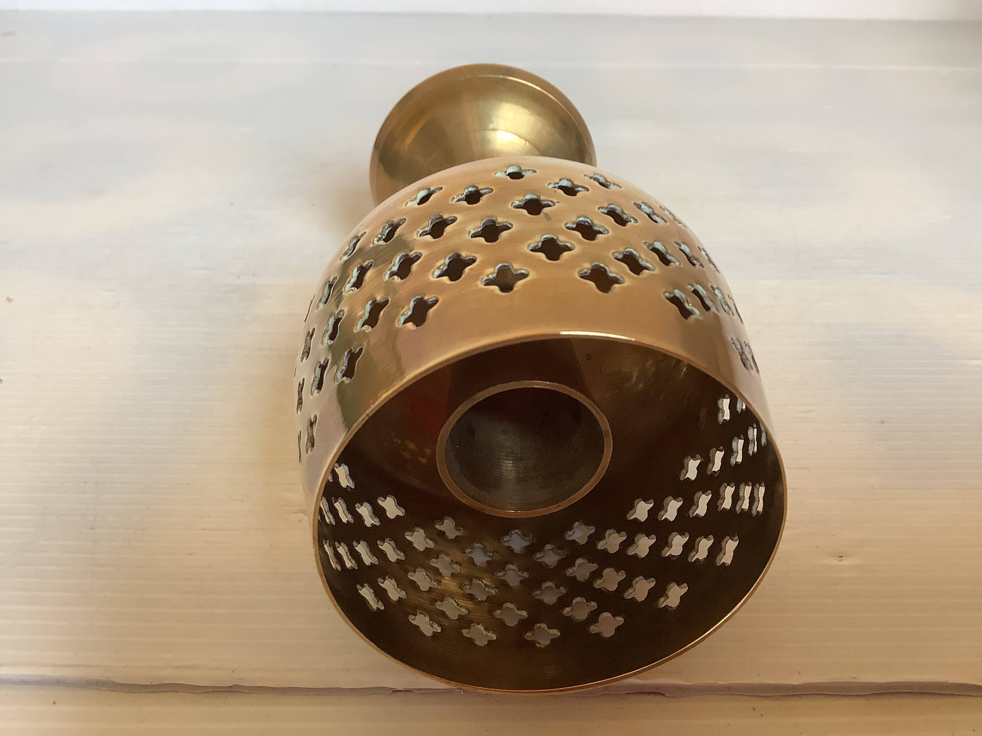 Lattice brass catchall and candlestick.