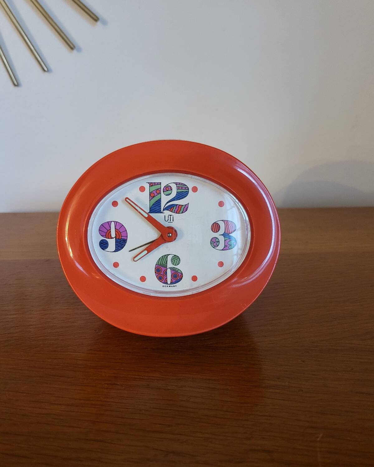 Vintage mechanical alarm clock in orange plastic Uti West Germany