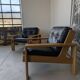 Pair of raw oak and leather armchairs by Esko Pajamies for Asko, Finland.