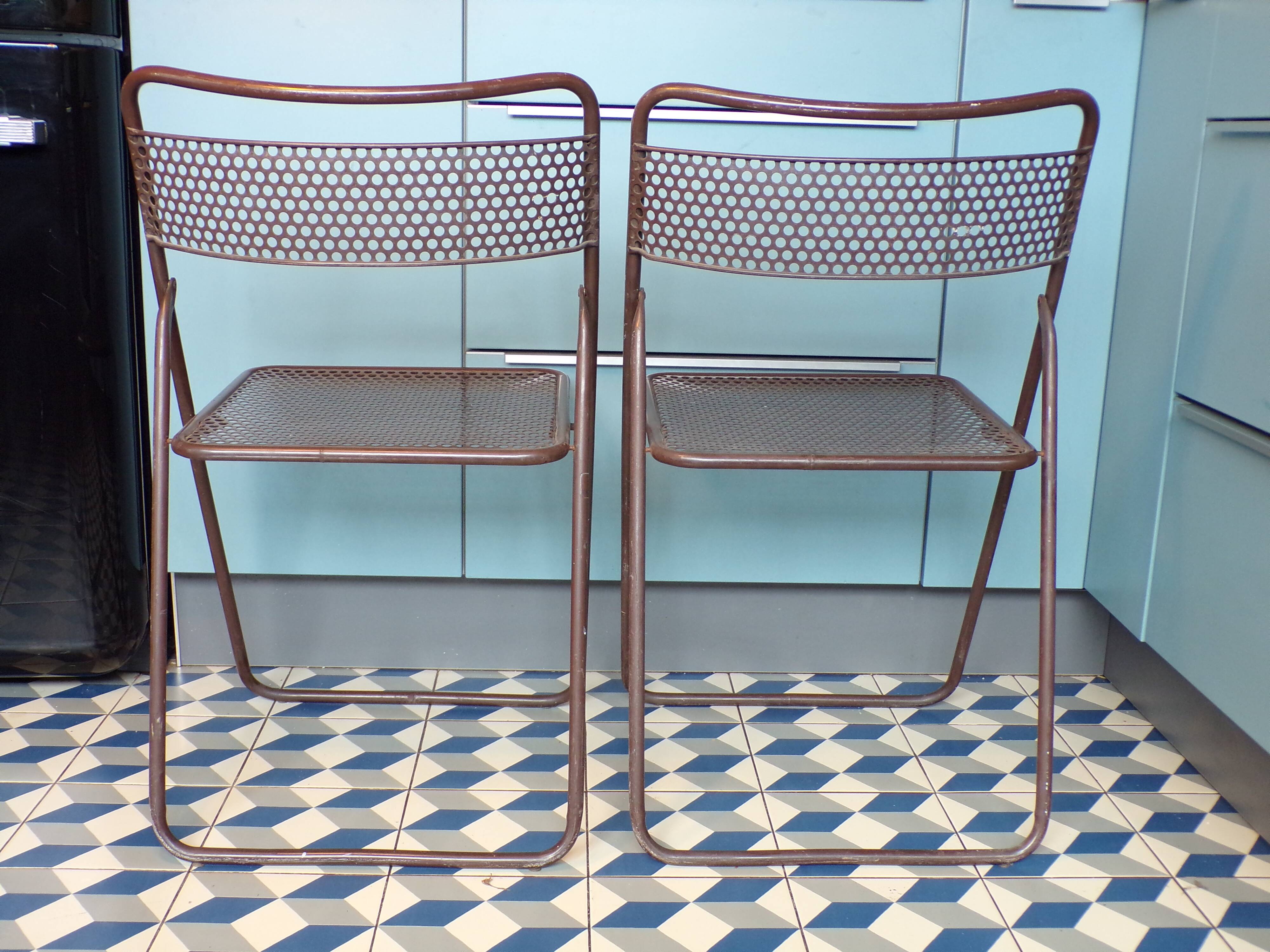 Pair of folding chairs in perforated sheet metal