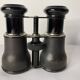 Old pair of binoculars sheathed leather black silver metal