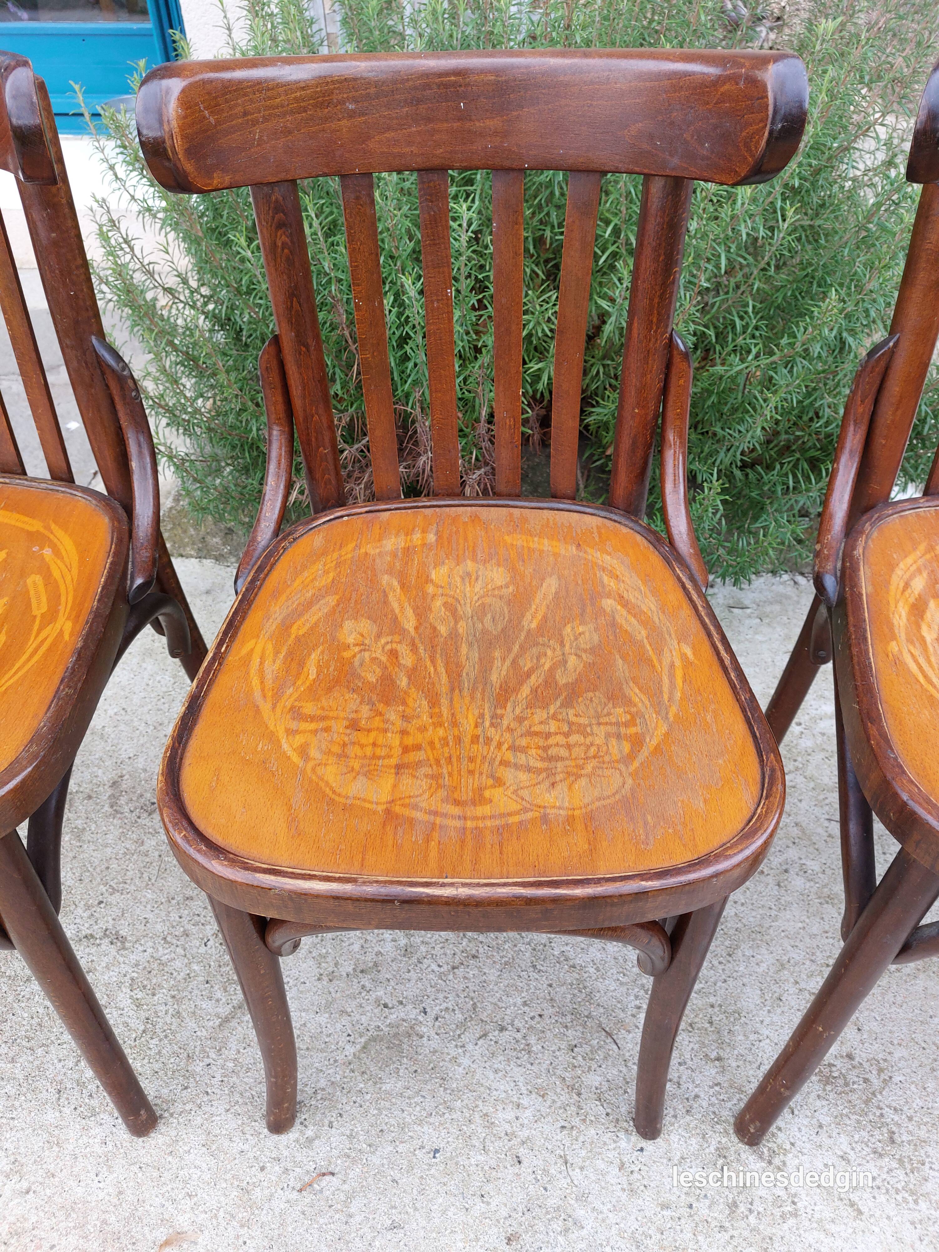 4 bentwood bistro chairs with a pattern on the seat