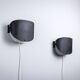 Matte black wall lamps with perforated shades and brass details