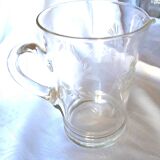 Blown glass pitcher decorated with small flowers