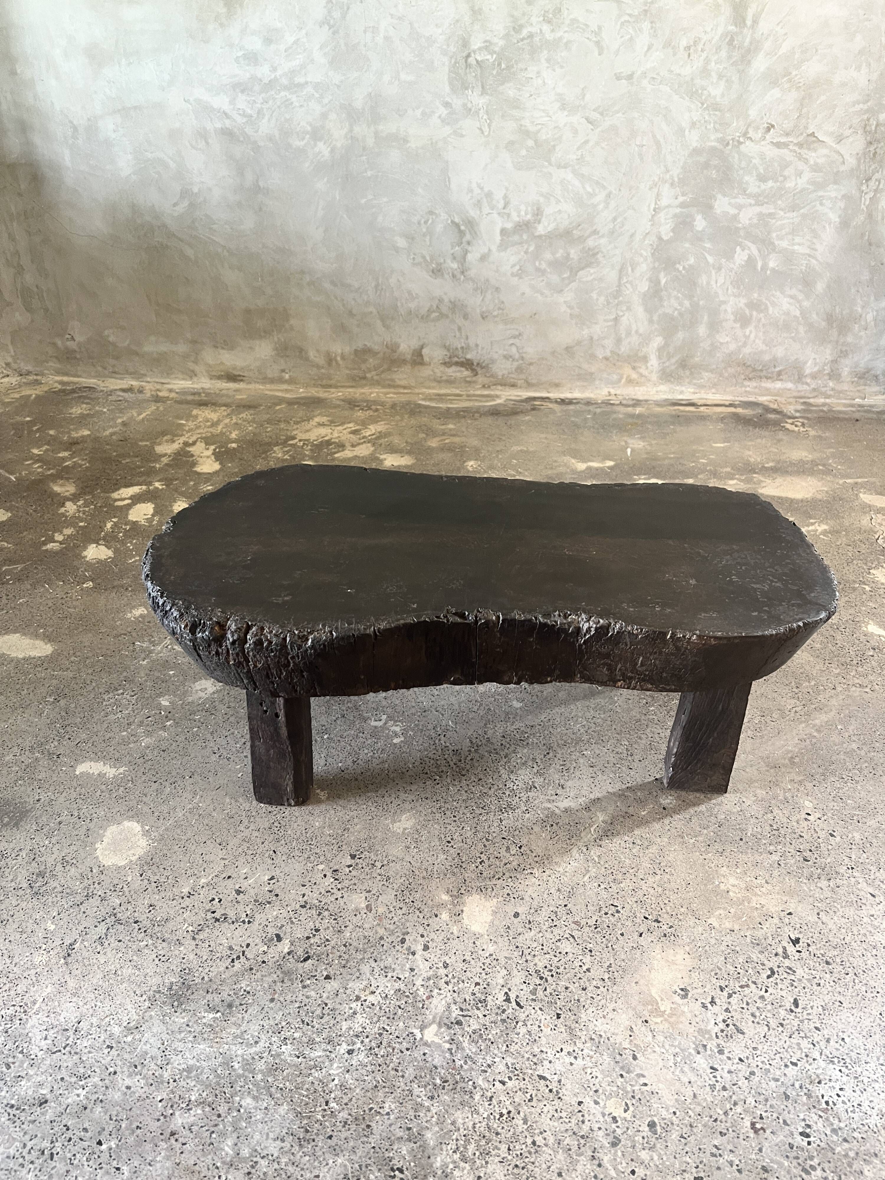 Small old Asian wooden coffee table in Japanese style, kidney-shaped top
