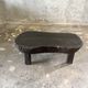 Small old Asian wooden coffee table in Japanese style, kidney-shaped top