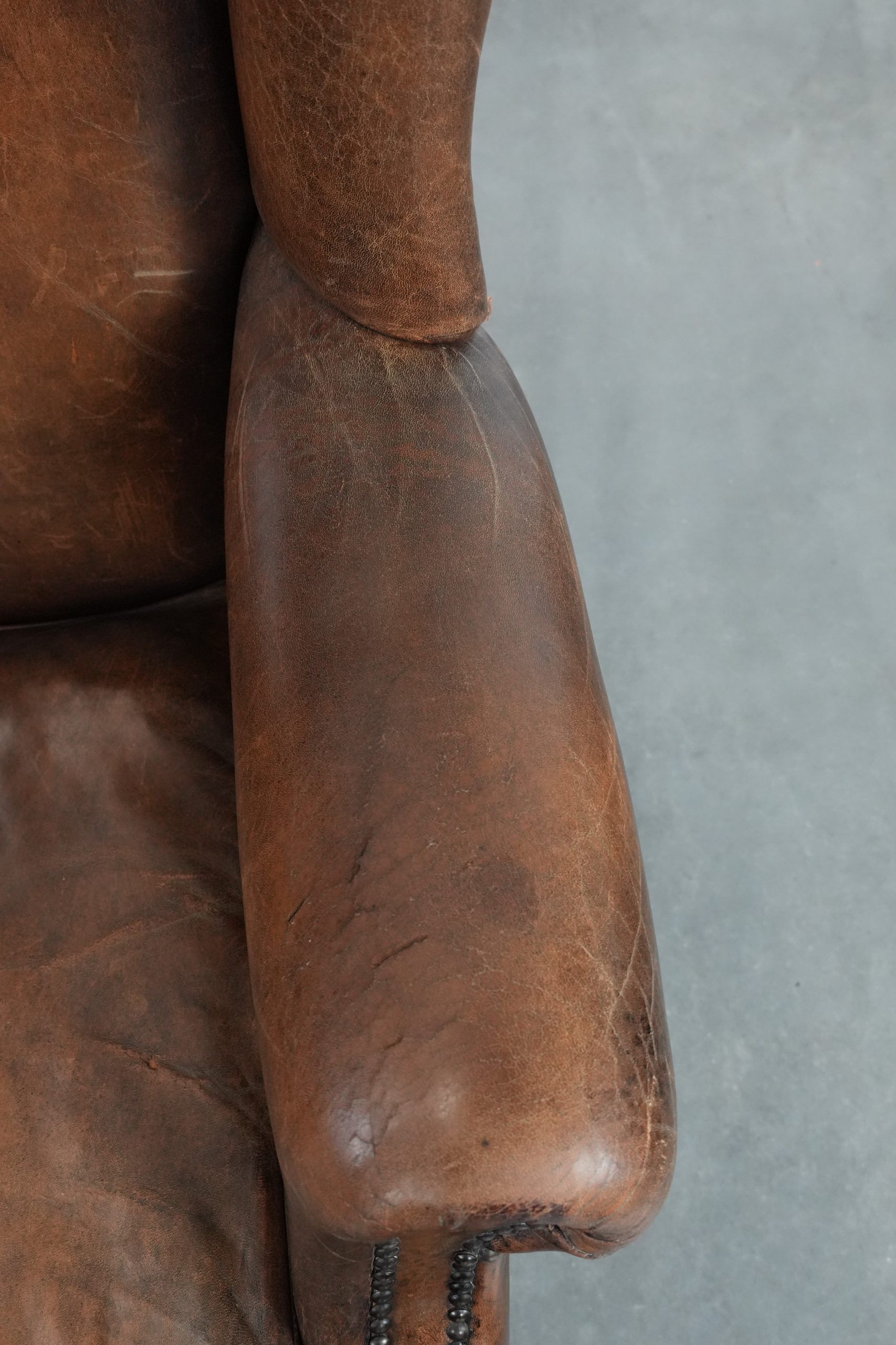 Vintage wingback armchair made of sheepskin leather with beautiful colours